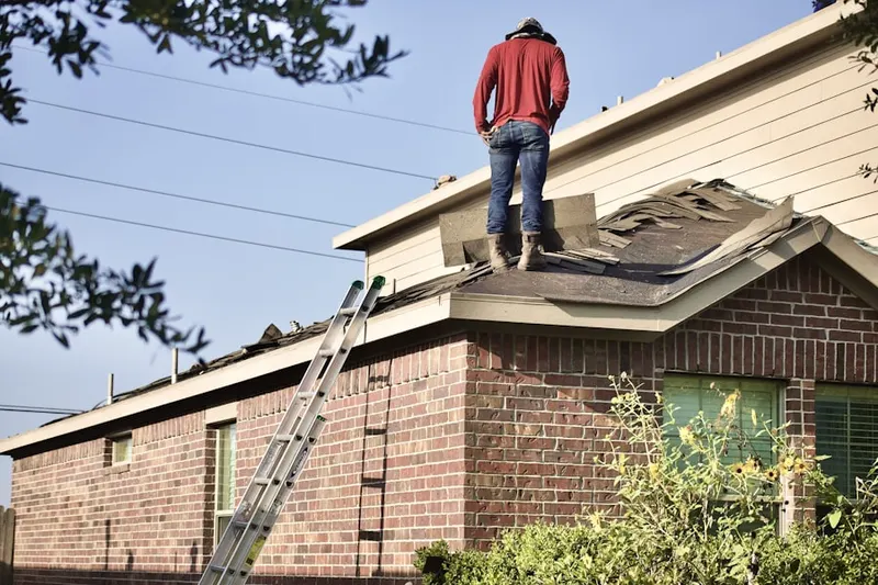 Professional roofer working on a residential roof in East Juniata